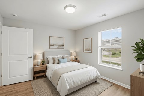 A bedroom with a large bed and a window overlooking a street.