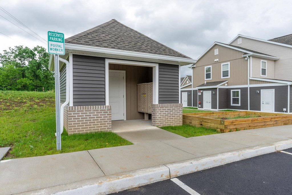 a small garage with a door open on a sidewalk