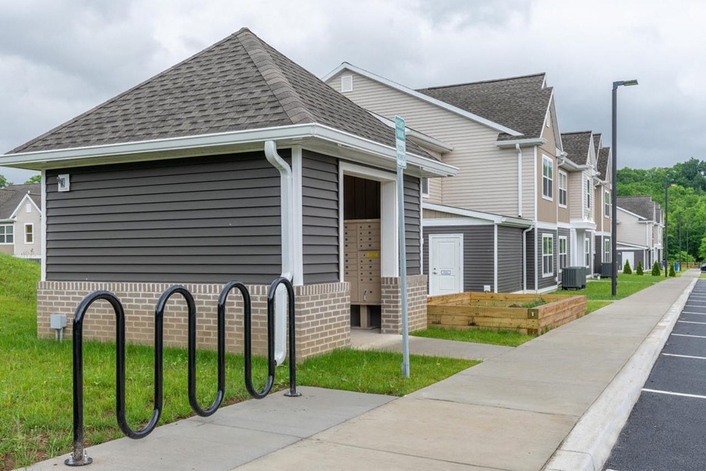 a row of houses with bike racks in front of them