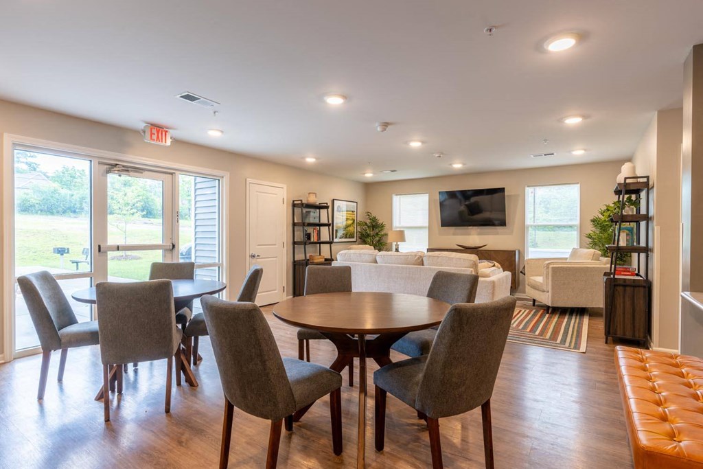 a dining room and living room with a table and chairs