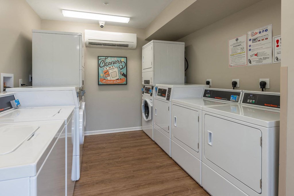 a washer and dryer room with laundry machines and cabinets