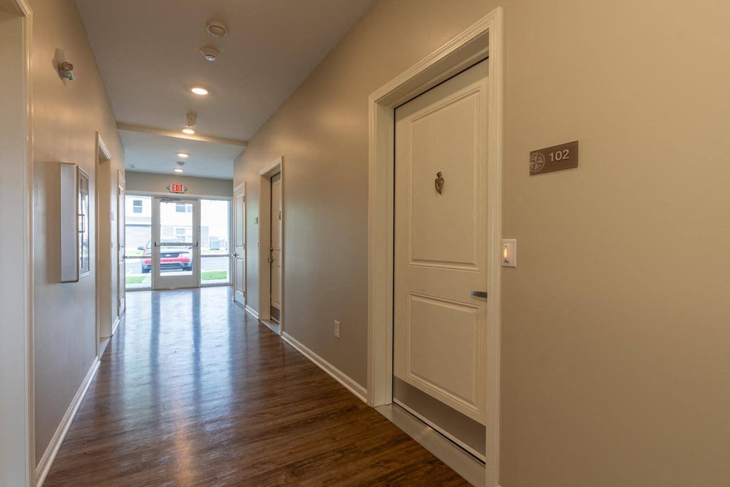 a hallway with a door and a door to a room
