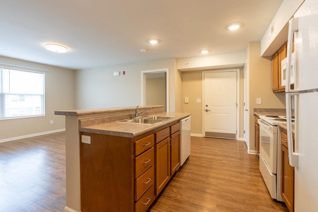 a kitchen with a sink and a refrigerator