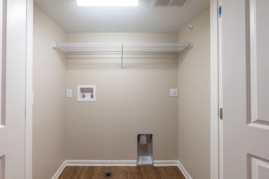 a empty room with a closet and a trash can in it