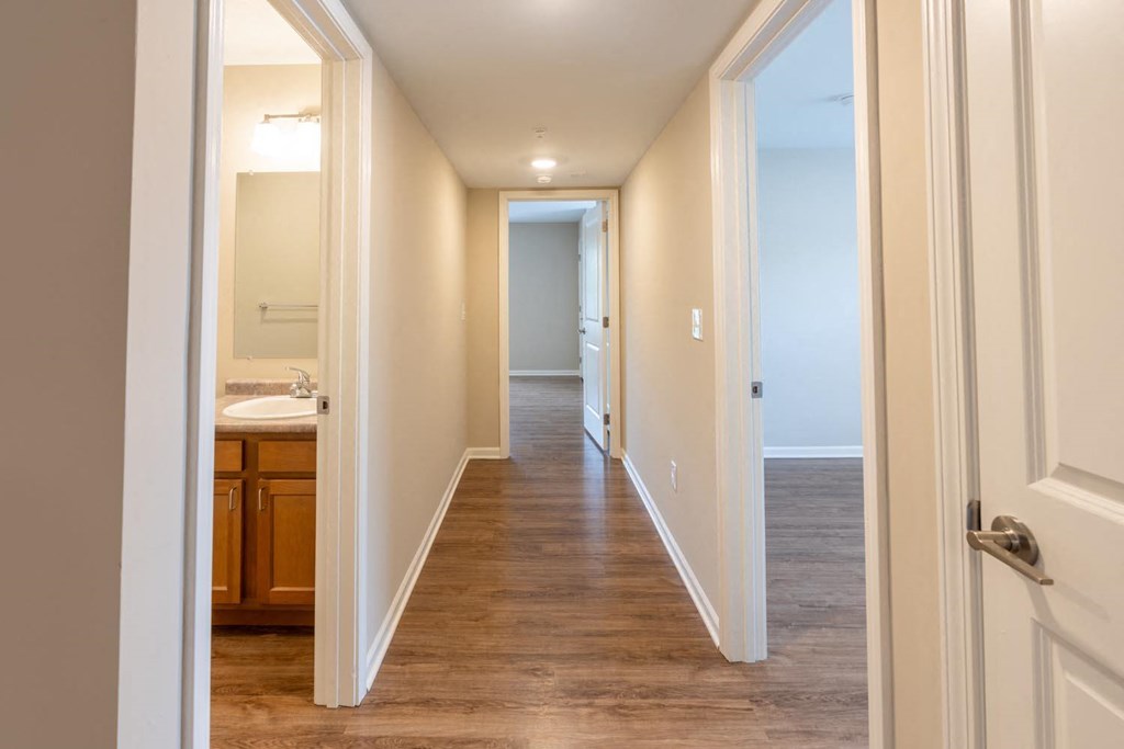 a renovated hallway with a bathroom and a sink