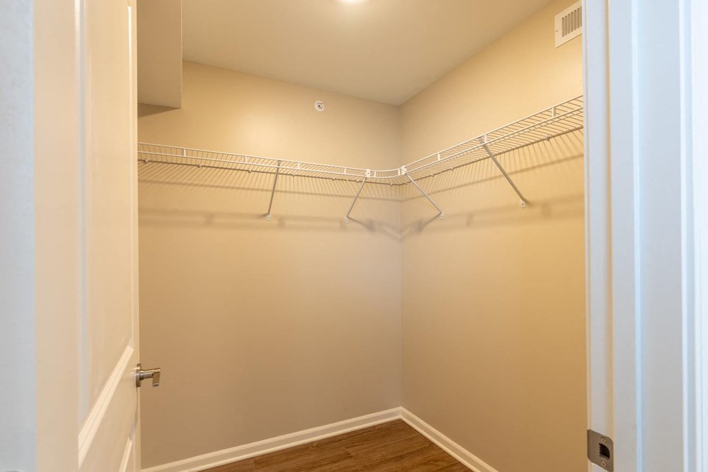 a closet with a wire shelf on the wall