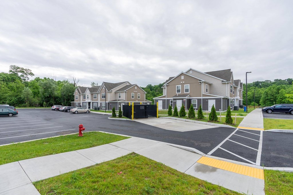 a red fire hydrant sitting on the side of a street