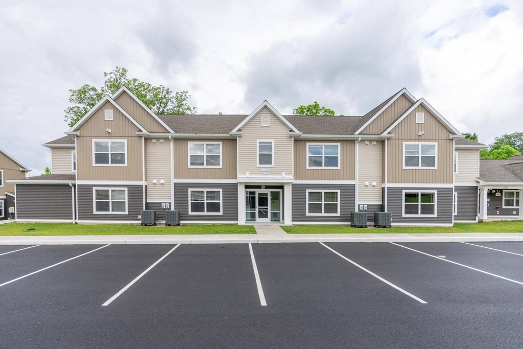 a large house with a parking lot in front of it