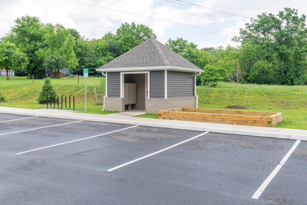 a small building in a parking lot with a bench