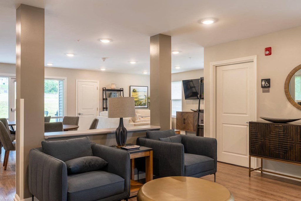 a living room with blue couches and a table
