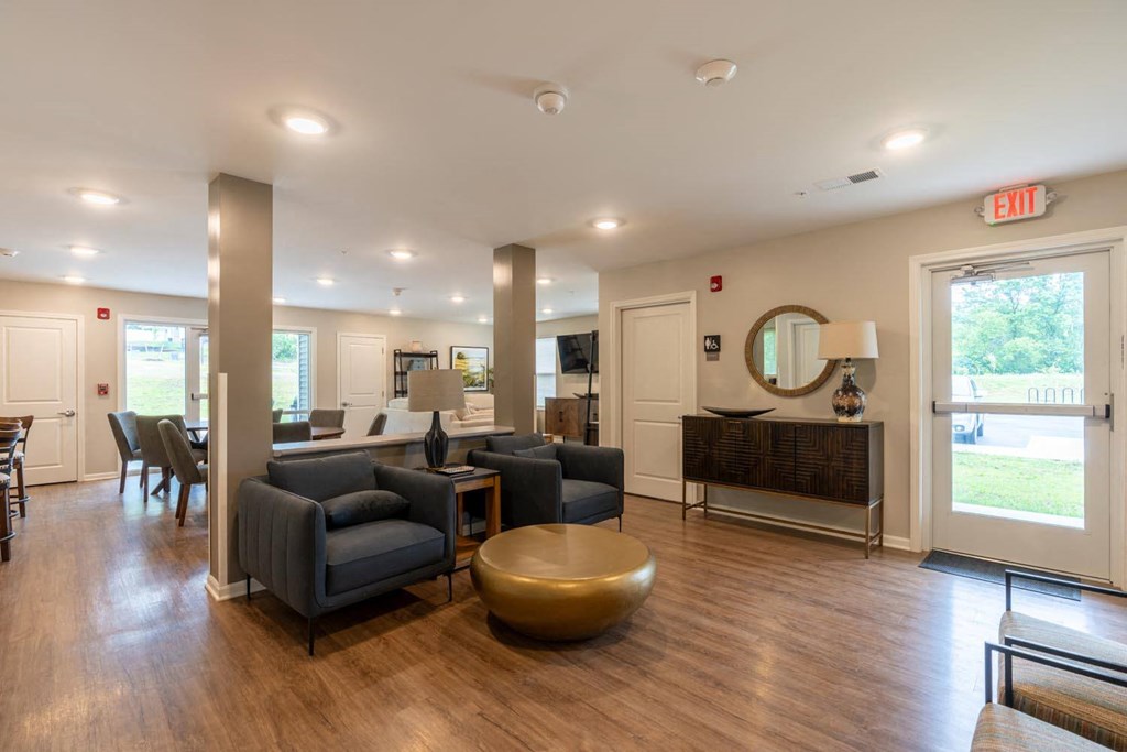 a living room with couches and chairs and a table