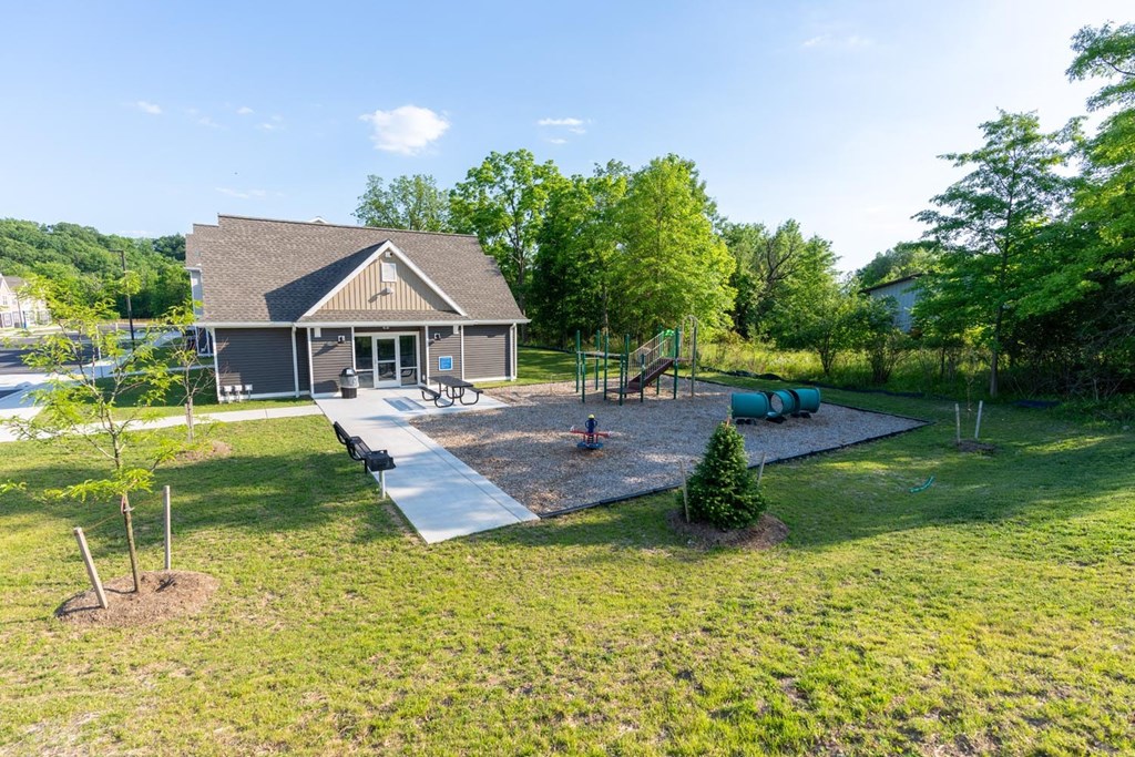 a backyard with a house and a playground