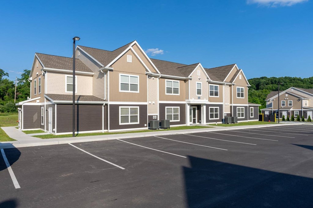 a parking lot in front of a row of houses