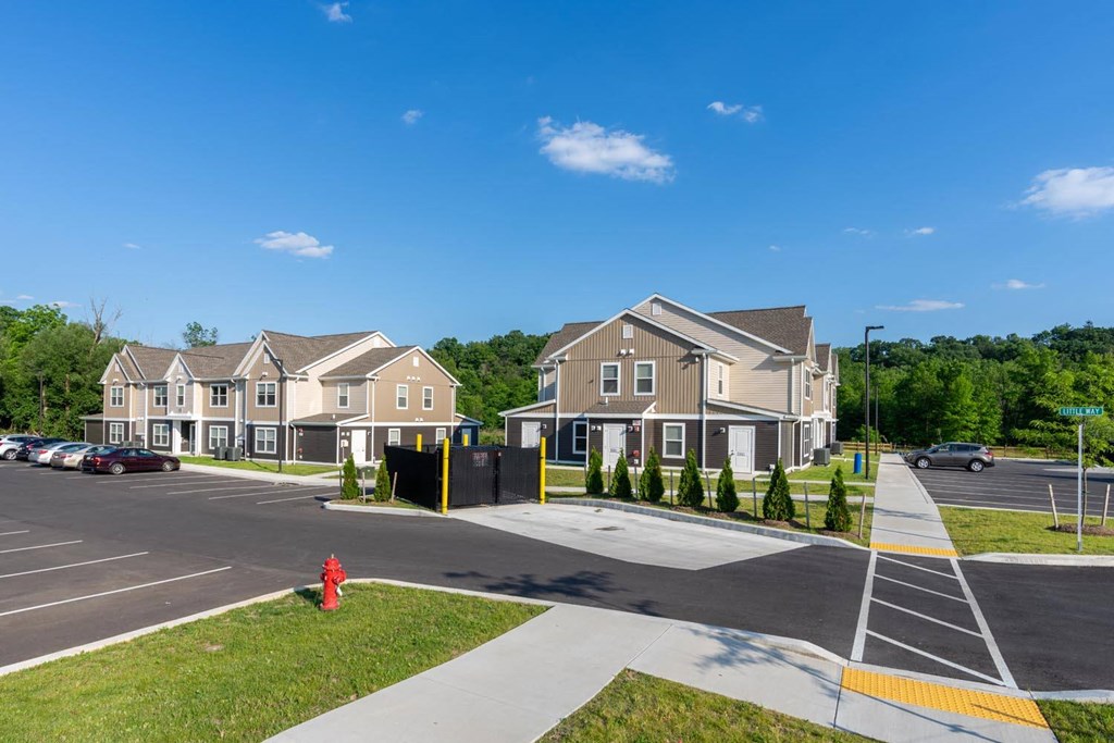 a red fire hydrant sitting on the side of a street