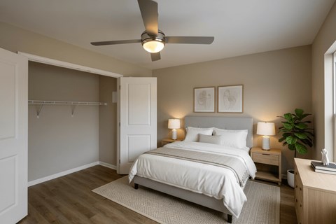 A bedroom with a bed, nightstand, and a ceiling fan.