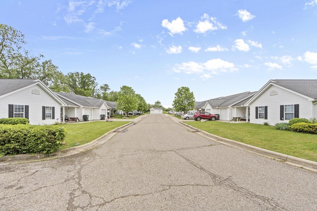 a street with white houses on both sides of a road