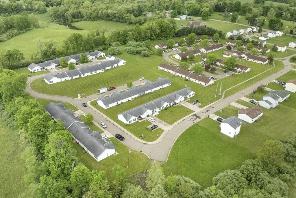 an aerial view of a neighborhood with houses and a road