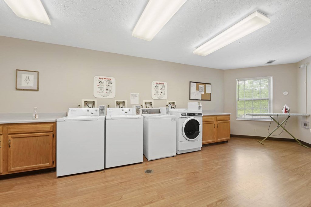 an image of a laundry room with washes and dryers