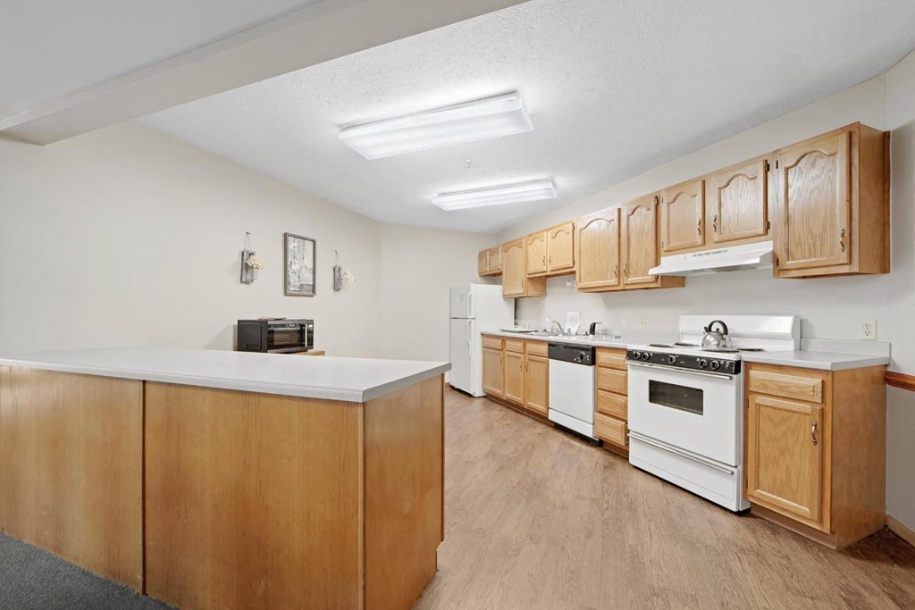 a kitchen with white appliances and wooden cabinets