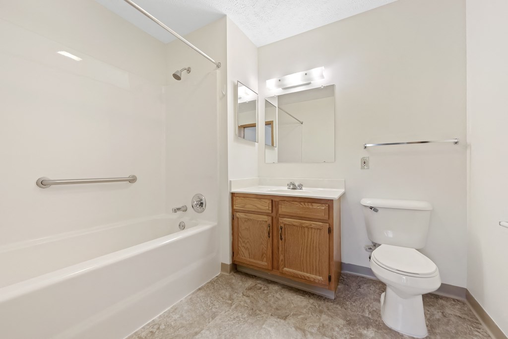 a bathroom with a toilet and a sink and a bath tub