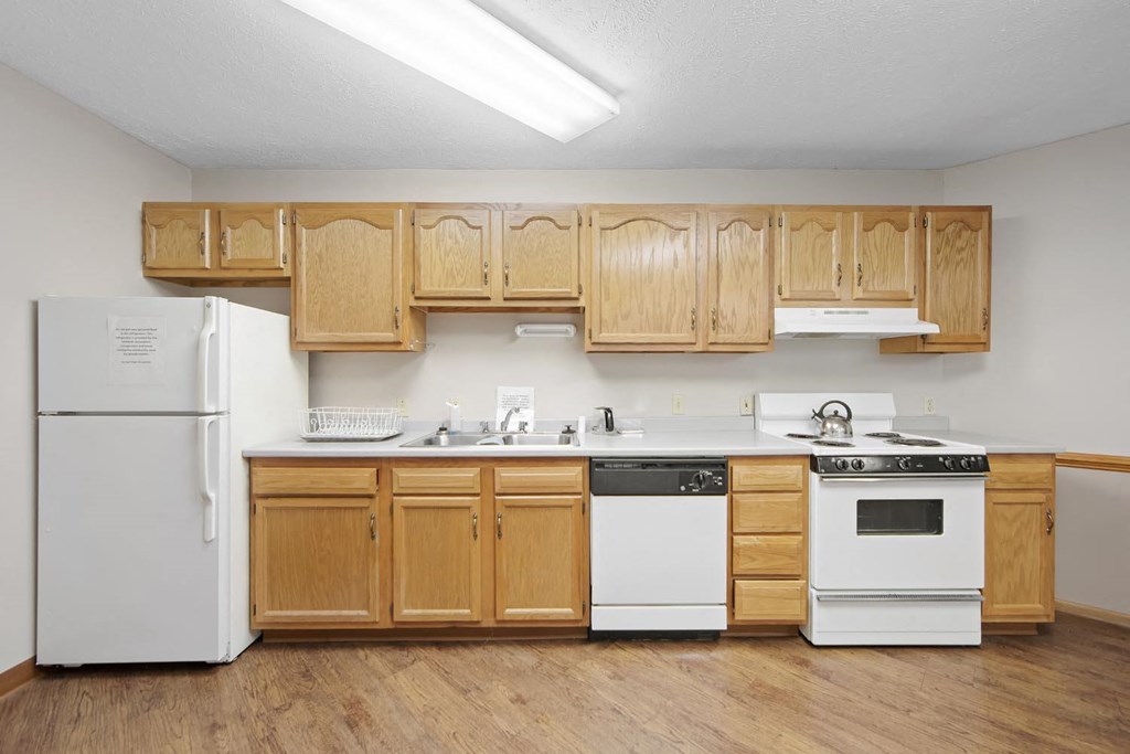 a kitchen with white appliances and wooden cabinets
