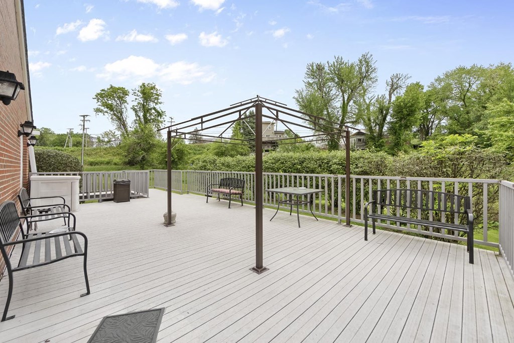 a large deck with benches and a swing