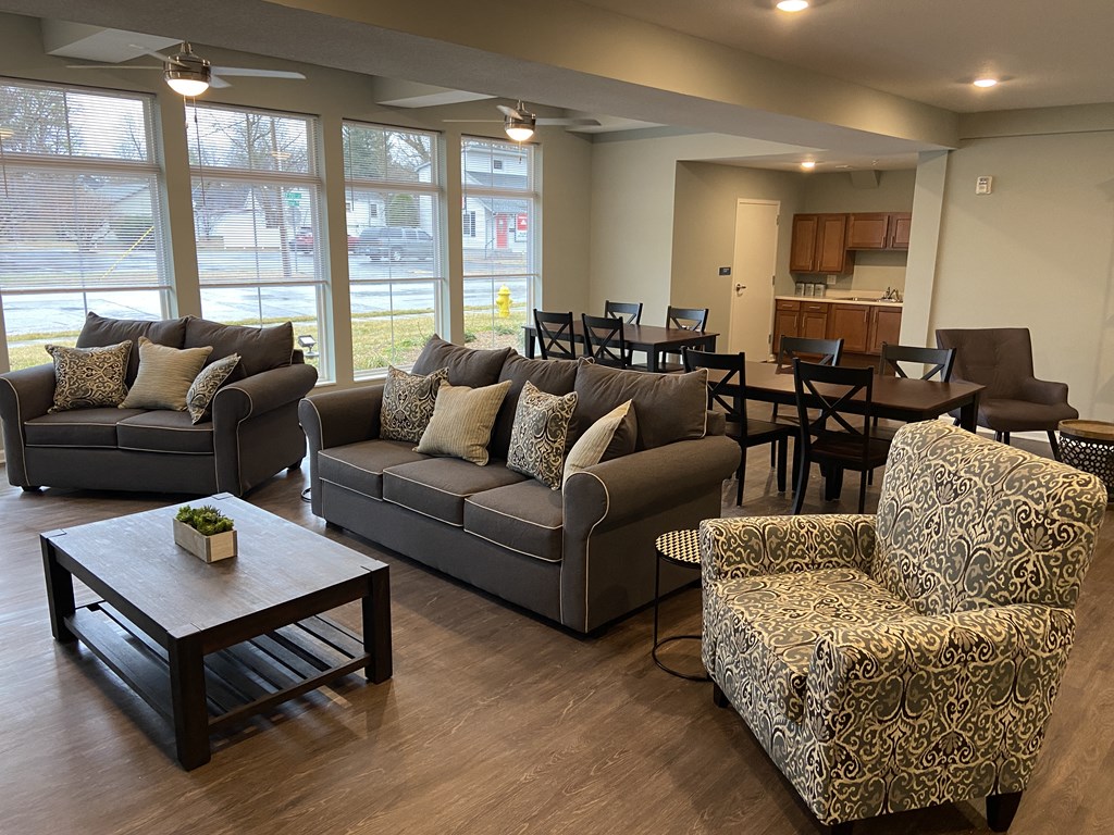 a living room and dining room with couches and a table