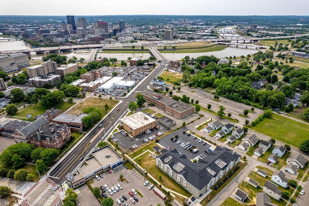 an aerial view of a city with a river in the background