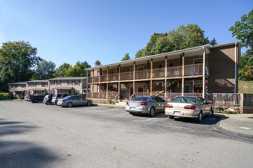 the parking lot is full of cars in front of a building
