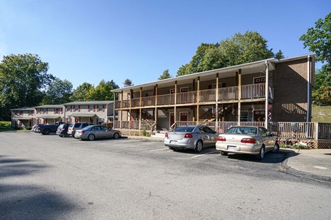 the parking lot is full of cars in front of a building