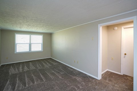 a empty room with a door and a window