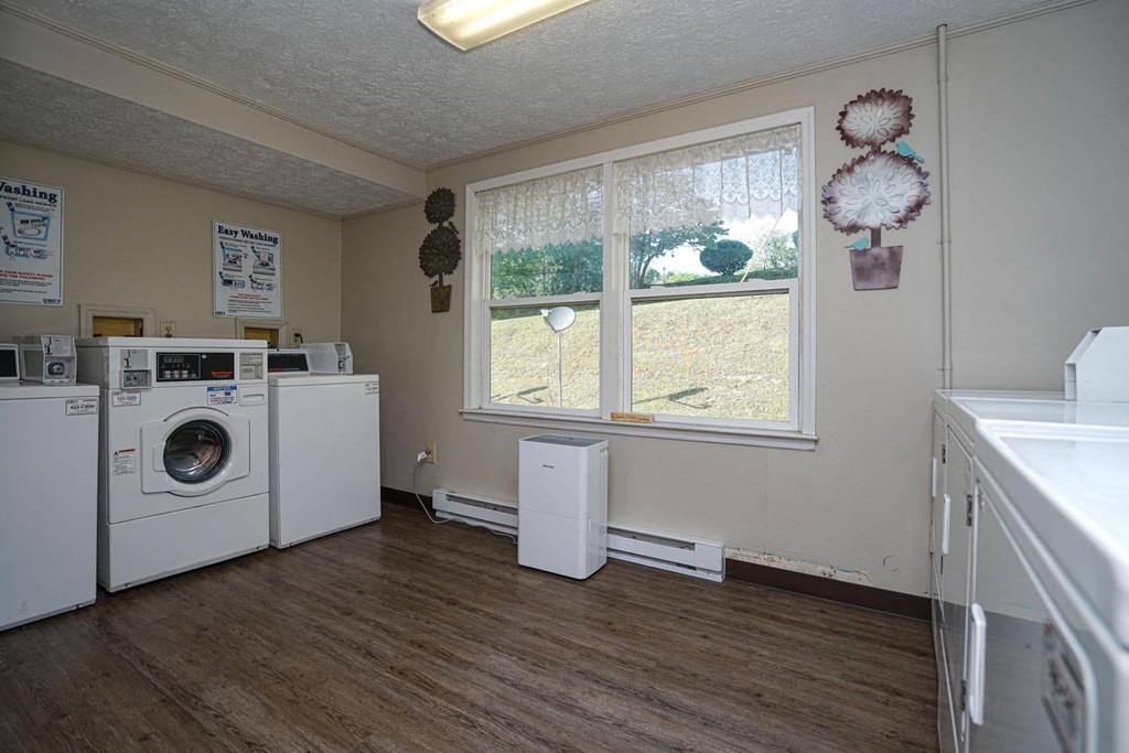 a kitchen with a washer and dryer and a window