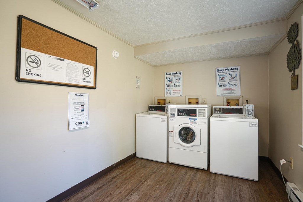 a laundry room with two washers and two washing machines