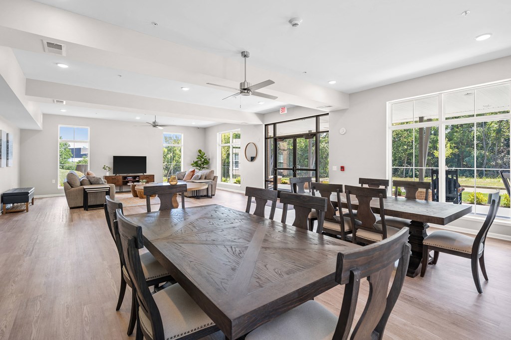 a large dining room with a large wooden table and chairs
