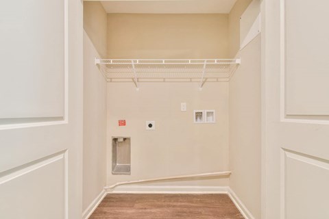 a room with white walls and a white shelf on the wall