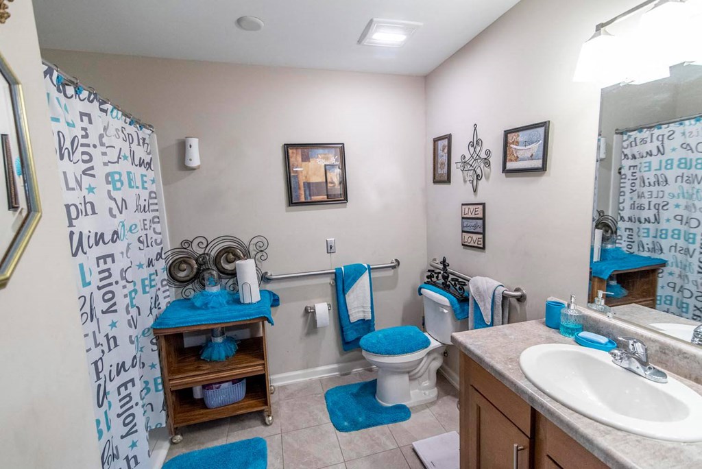 a bathroom with a toilet sink and shower