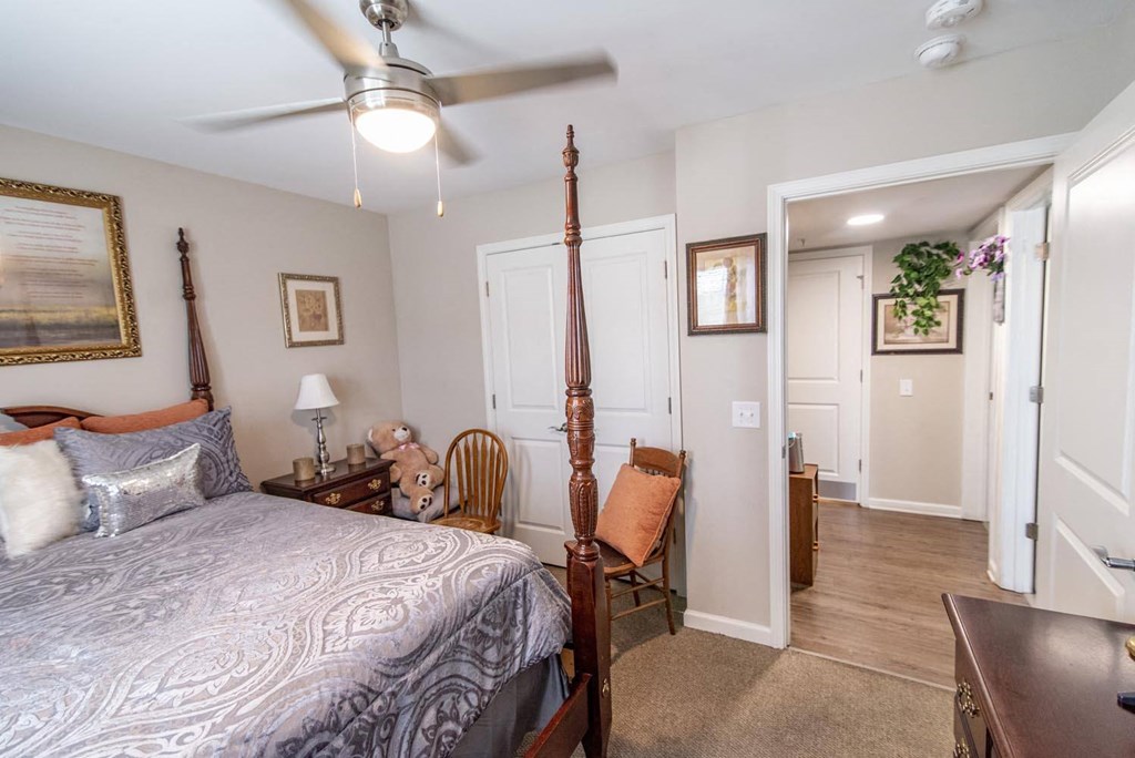 a bedroom with a bed and a ceiling fan