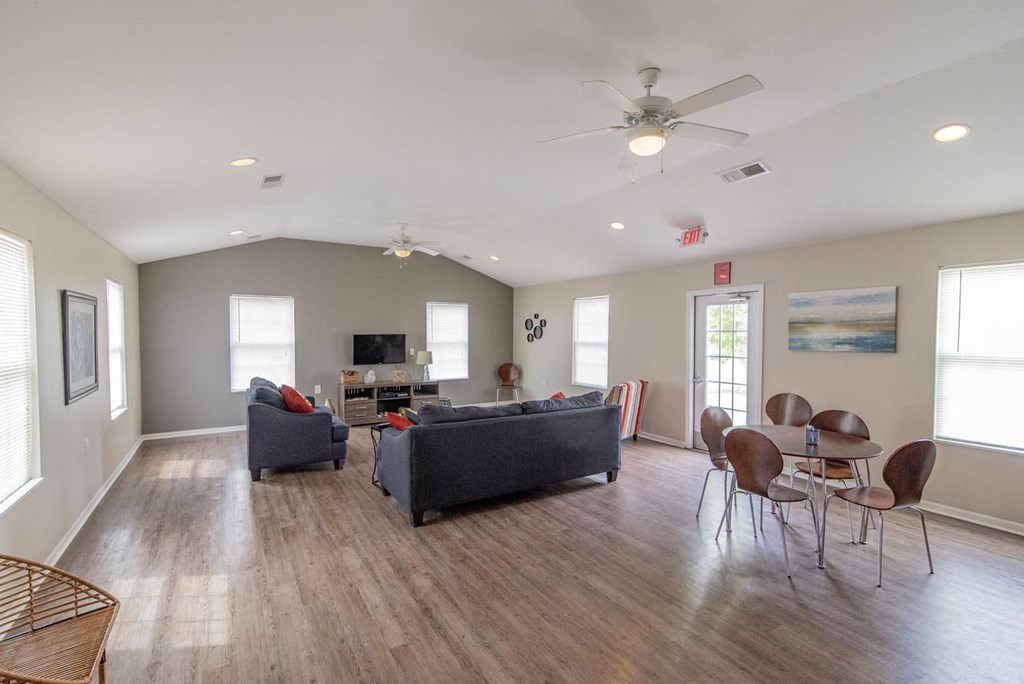 a living room with couches and a table with chairs