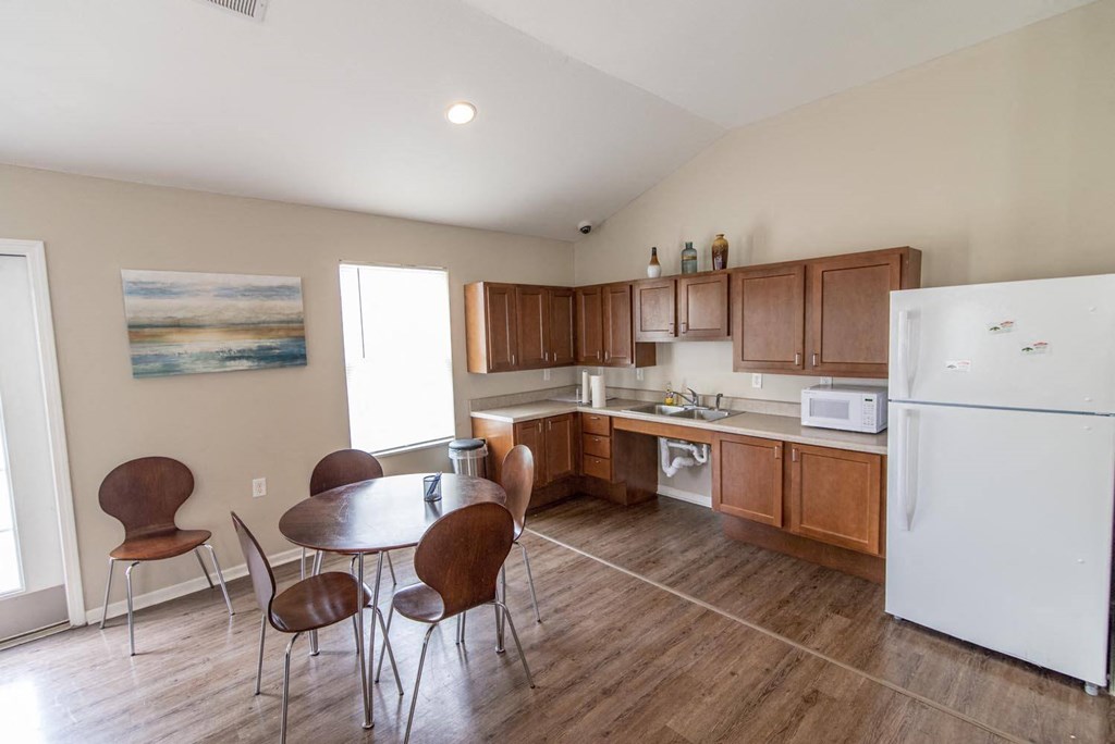 a kitchen with wooden cabinets and a white refrigerator