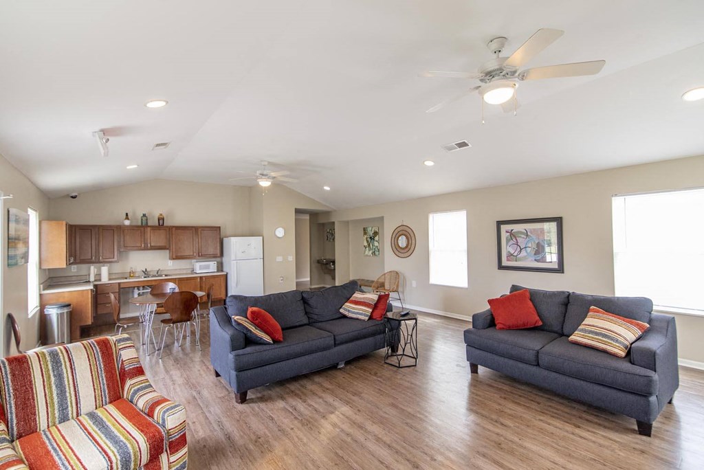 a living room with couches and chairs