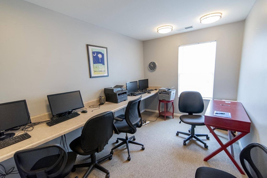 a room with four computers and four chairs