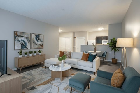 A living room with a white couch, a blue chair, and a television.
