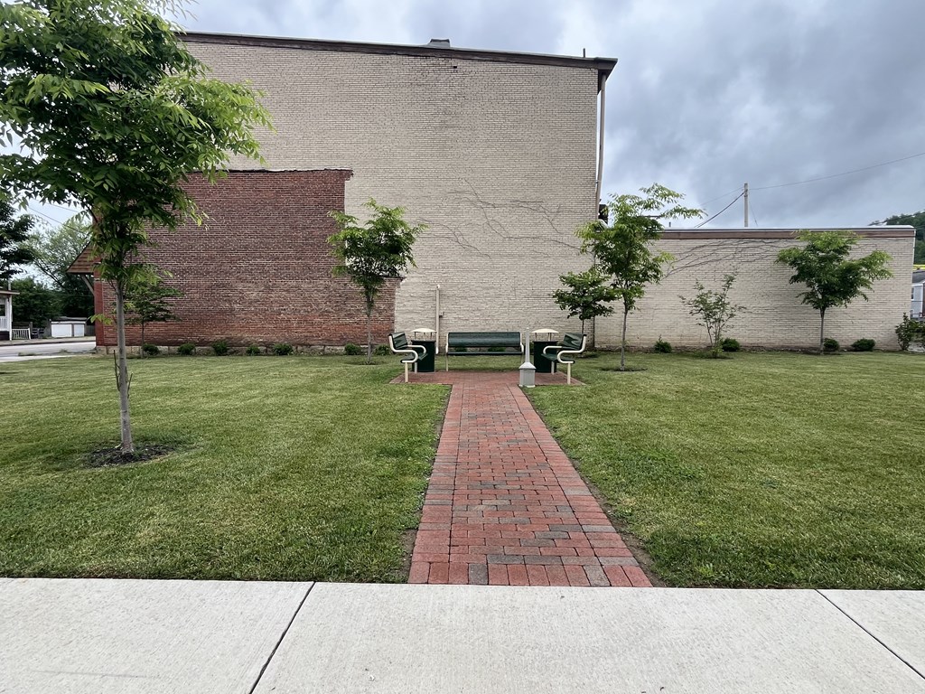 a park bench in front of a brick building