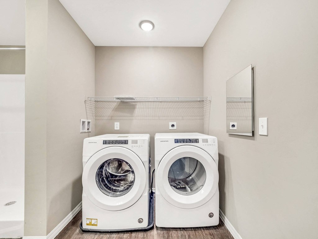 a washer and dryer in a laundry room with white walls