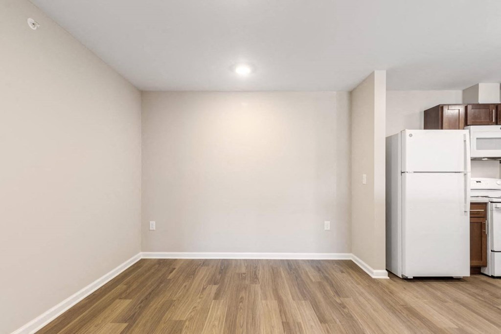A kitchen area with a white fridge and a white oven.
