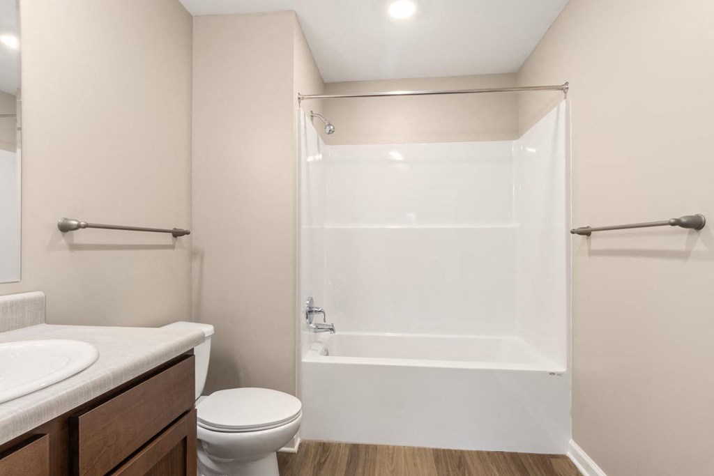 A white toilet sits next to a sink in a small bathroom.