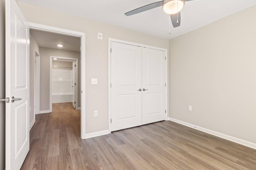 A room with a white door and a white cabinet.