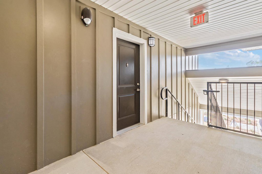 A room with a door and a window with a view of the outside.