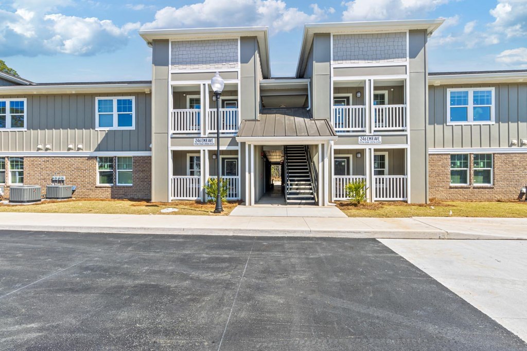 A large two-story building with a parking lot in front.