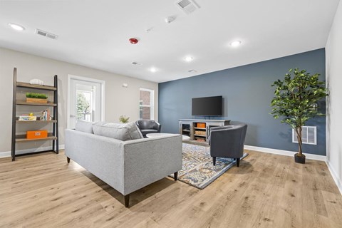 A living room with a grey sofa and a grey armchair.